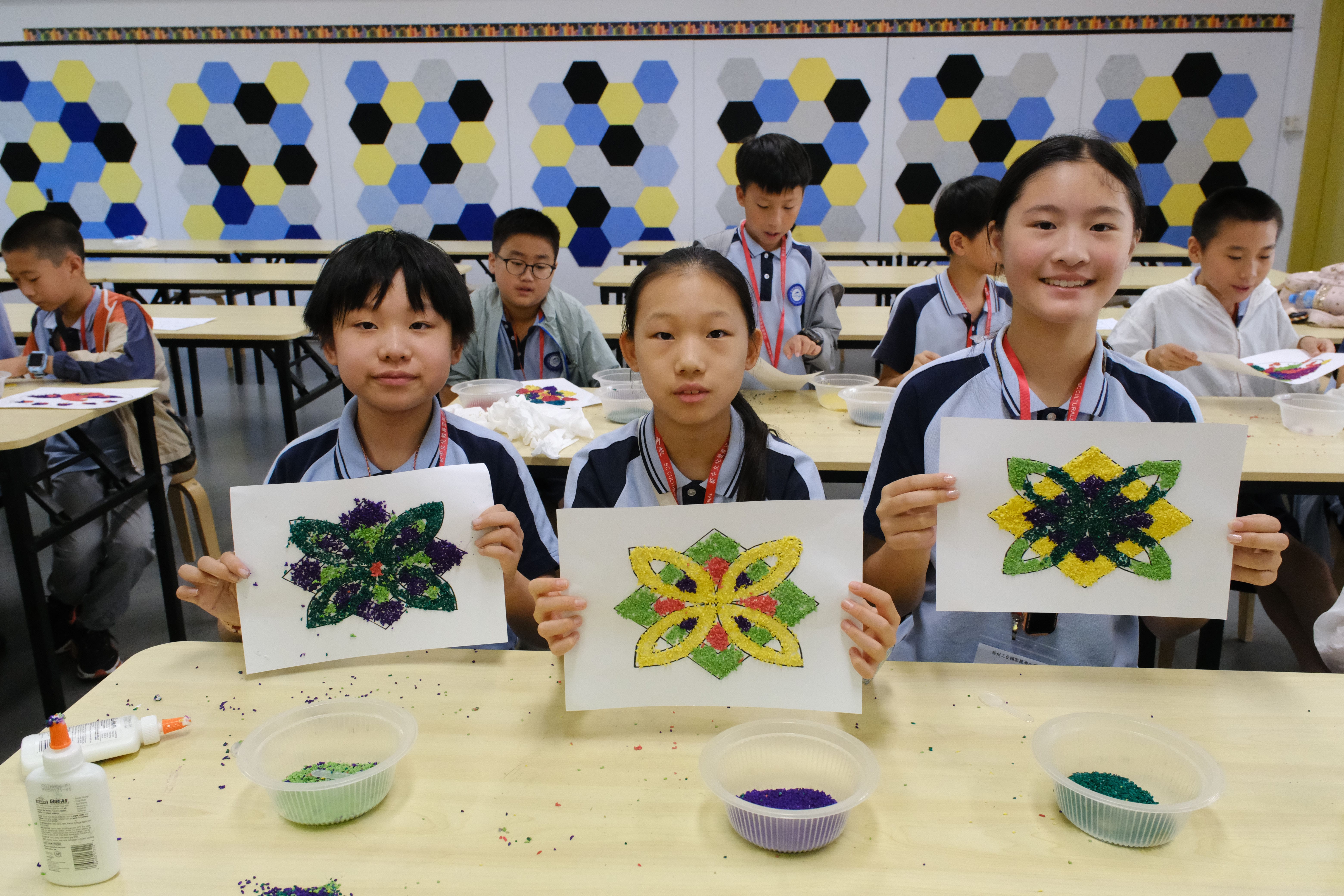 Students proudly showcased their colourful kolam creations.